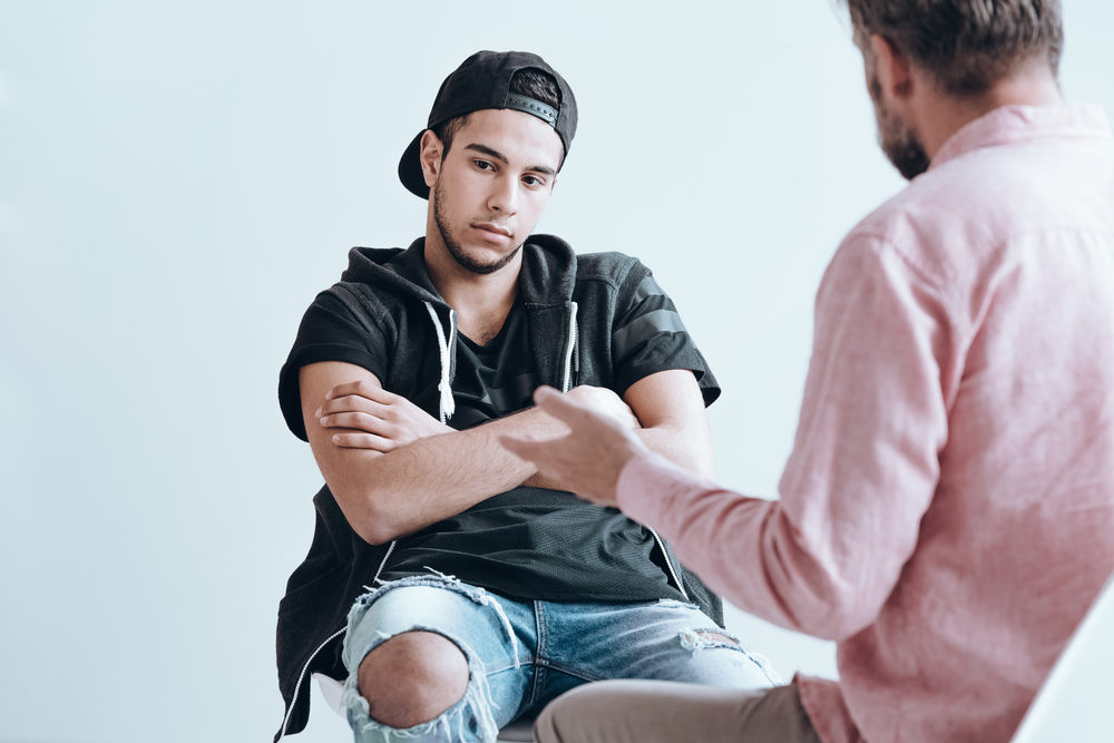 Teenager deep in thought during a an individual therapy for heroin addiction